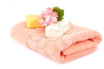 Folded towel and soaps isolated on white background.