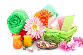 Spa set with towels, creams, lotions, candles, stones and flowers isolated on white background.