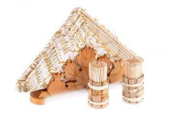 Paper napkins in wooden holder and toothpicks isolated on white background.