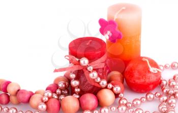 Colorful candles and necklaces on white background.