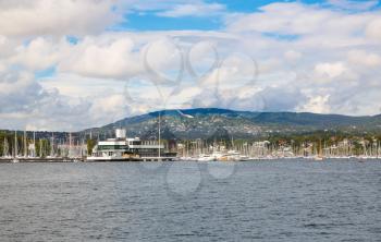 Coastline in Oslo with boats, port and buildings.