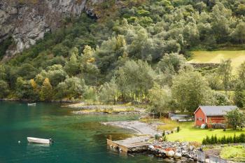 Landscape with Naeroyfjord, mountains and traditional village house in Norway.