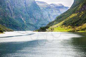 Landscape with Naeroyfjord, mountains and traditional village in Norway.