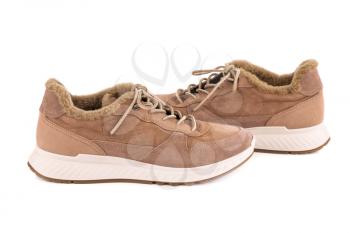 The pair of stylish suede shoes isolated on white background.