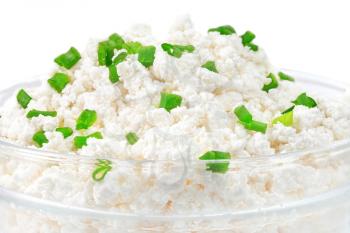 Fresh cottage cheese (curd) in glass bow, isolated on white background.