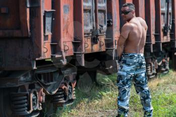 Muscular Man Pissing On Railroad