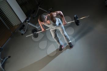 Man Doing Exercise For Back With Barbell