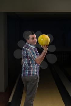 Man Holding A Bowling Ball