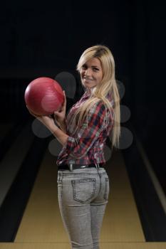 Women Holding A Bowling Ball