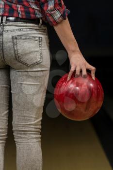 Close-Up Of A Butt Next To A Bowling Ball