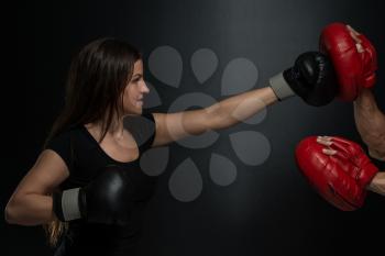 Bodybuilding Couple Posing With Boxing Gloves On Black Background