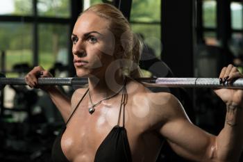 Female Bodybuilder Doing Heavy Weight Exercise For Legs Barbell Squat