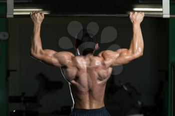 Male Athlete Doing Pull Ups - Chin Ups In The Gym