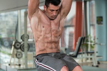 Young Man Performing Hanging Leg Raises Exercise - One Of The Most Effective Ab Exercises