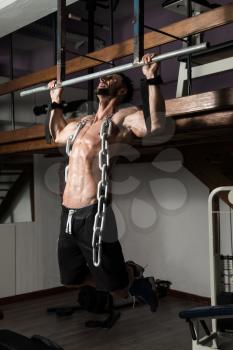 Bodybuilder Doing Heavy Weight Exercise For Back With Chains