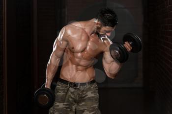 Healthy Man Working Out Biceps - Dumbbell Concentration Curls