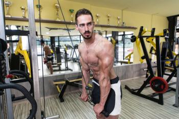 Young Bodybuilder Exercise Triceps In The Gym - He Is Performing Two Arm Triceps Push Downs
