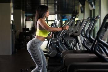 Fitness Girl Exercising On Moonwalker Treadmill Gym Equipment
