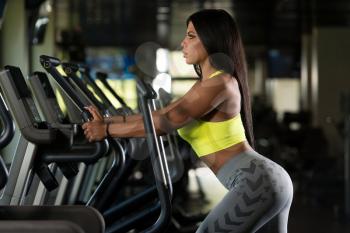 Fitness Girl Exercising On Moonwalker Treadmill Gym Equipment