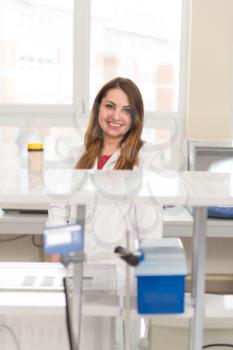 Portrait Of A Woman Student In A Chemistry Lab Smiling And Looking In The Camera
