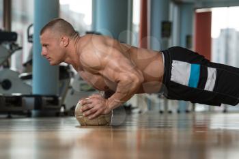 Young Adult Athlete Doing Push Ups On Medicine Ball As Part Of Bodybuilding Training
