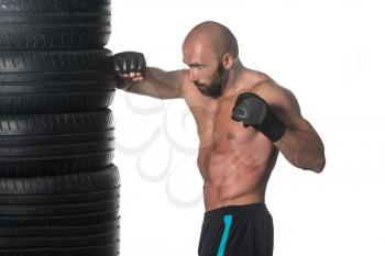 Muscular Sports Guy Boxing Workout Over White Background Isolated - Boxer Is Hitting A Rubber