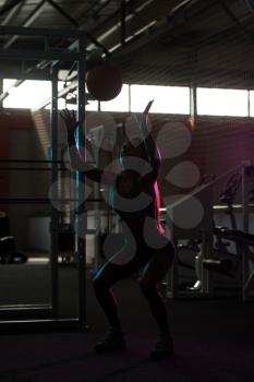 Silhouette Woman Exercising Ball In The Gym