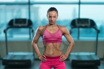 Portrait Of A Young Physically Fit Woman Showing Her Well Trained Body - Muscular Athletic Bodybuilder Fitness Model Posing After Exercises