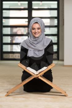 Beautiful Muslim Woman Wearing Hijab And Reading The Koran