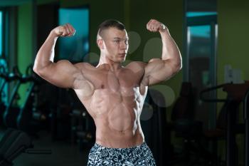 Portrait Of A Young Physically Fit Man Showing His Well Trained Body - Muscular Athletic Bodybuilder Fitness Model Posing After Exercises