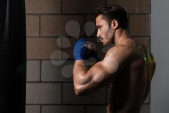 Handsome Man In Blue Boxing Gloves - Boxing In Gym - The Concept Of A Healthy Lifestyle - The Idea For The Film About Boxing