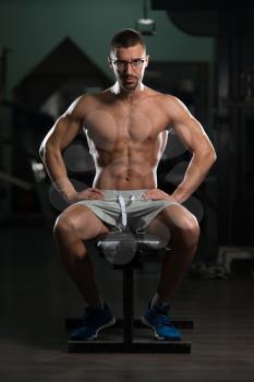 Handsome Good Looking And Attractive Young Man In Glasses With Muscular Body Relaxing In Gym
