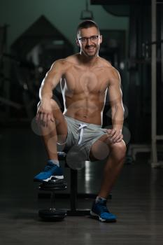 Handsome Good Looking And Attractive Young Man In Glasses With Muscular Body Relaxing In Gym