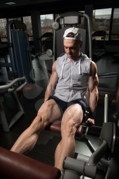 Leg Exercises Close Up -  Man Doing Leg With Machine In Gym