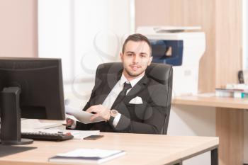 Portrait Of A Young Business Man Using A Computer In The Office