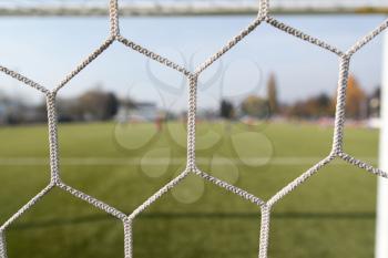White Soccer or Football Net With Blurred Field Background