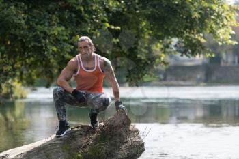 Handsome Good Looking And Attractive Adult Man With Muscular Body Relaxing Outdoors In Nature