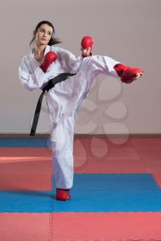 Young Woman Practicing Her Karate Moves - White Kimono - Black Belt