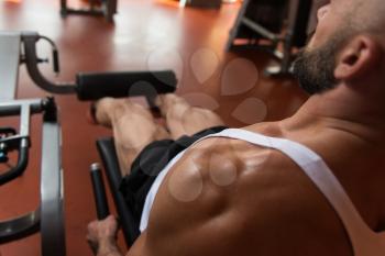 Leg Exercises -  Man Doing Leg With Machine In Gym