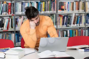 Young Man Student Feel Bored While Trying to Studying Entry Exams to University or College