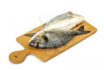 Dorado fish on wooden cutting board isolated on white