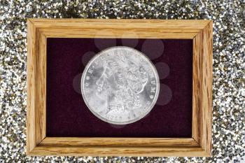 Fine Silver Dollar in Jewelry box with glitter in background