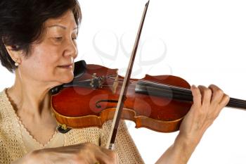 Closeup horizontal photo of a senior woman playing the violin on white background 