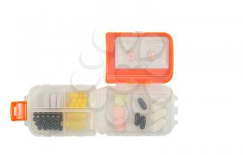 Small plastic medicine container filled with various pills inside isolated on white