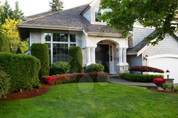Beautiful home exterior during late spring season with clean landscape  