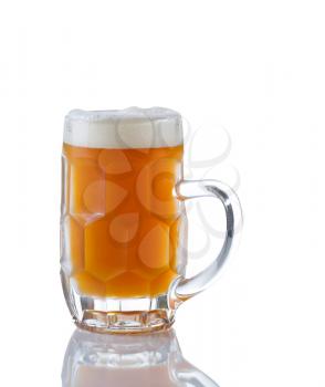 Vertical image of a Glass Stein filled with fresh amber beer on white with reflection