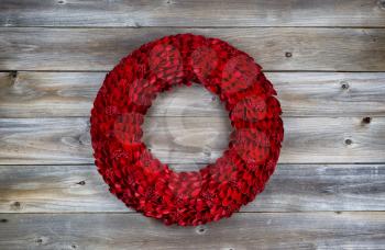 Wooden Red holiday wreath on rustic wood 