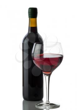 Glass of red wine with full bottle in background on white with reflection