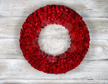 Wooden Red holiday wreath on white boards 