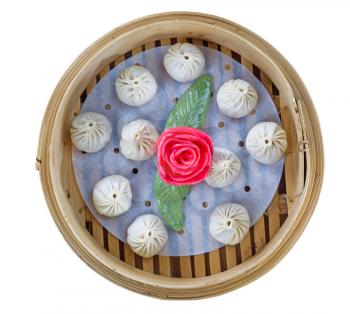Square top view image of uncooked Chinese Dim sum in bamboo server
